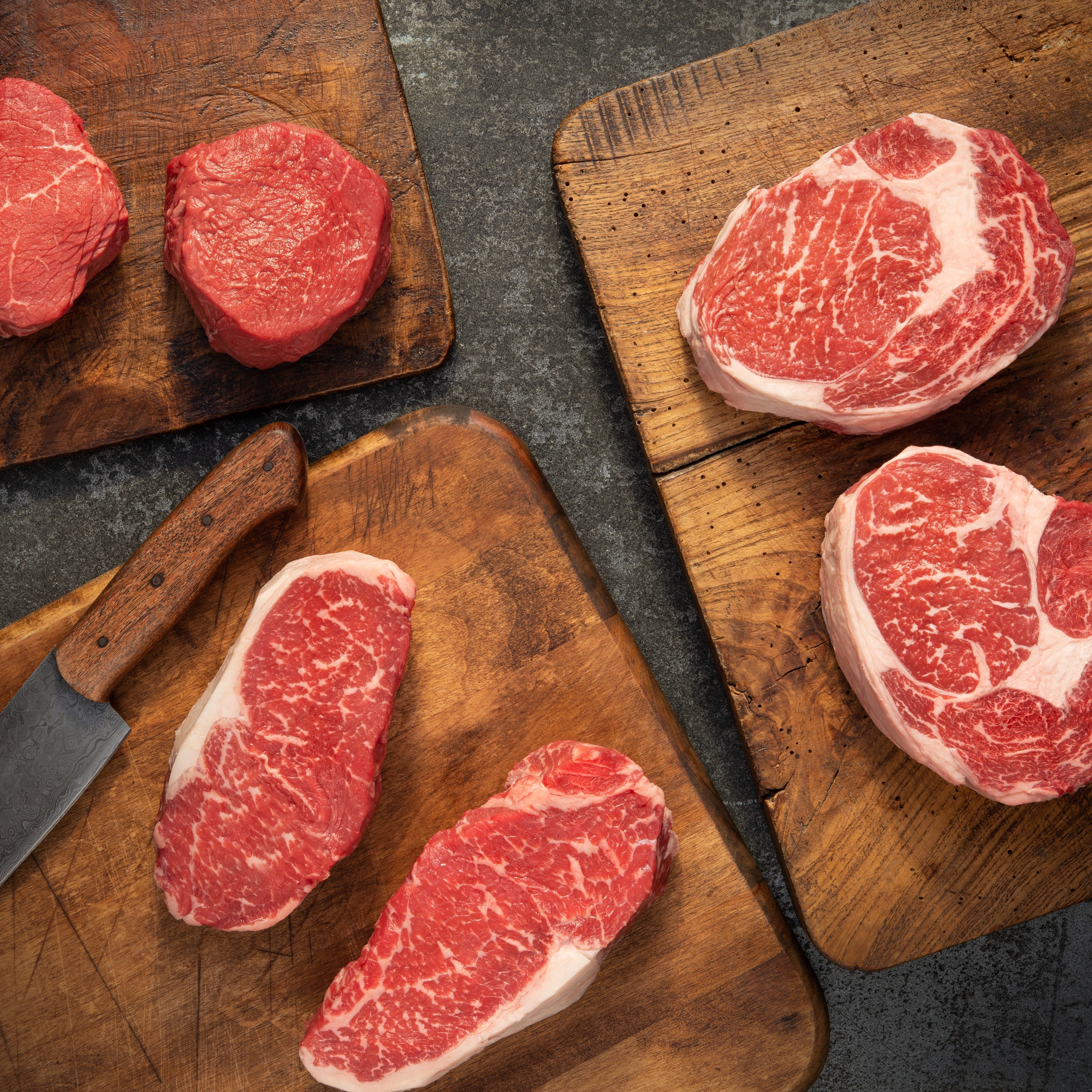 44 Farms premium beef and steak bundle on cutting board with butcher knife