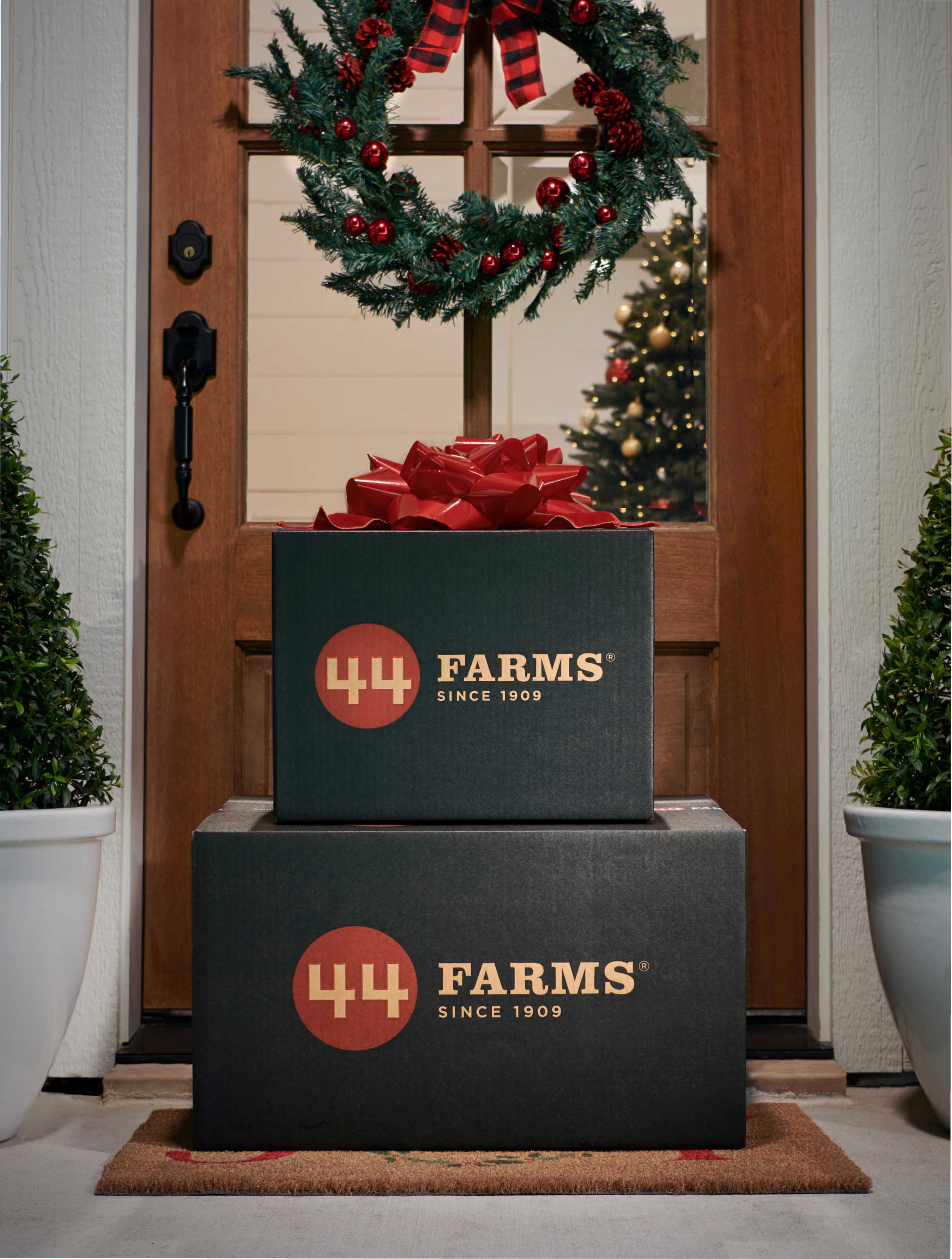 44 farms gift boxes with bow on front porch with holiday decorations for black friday