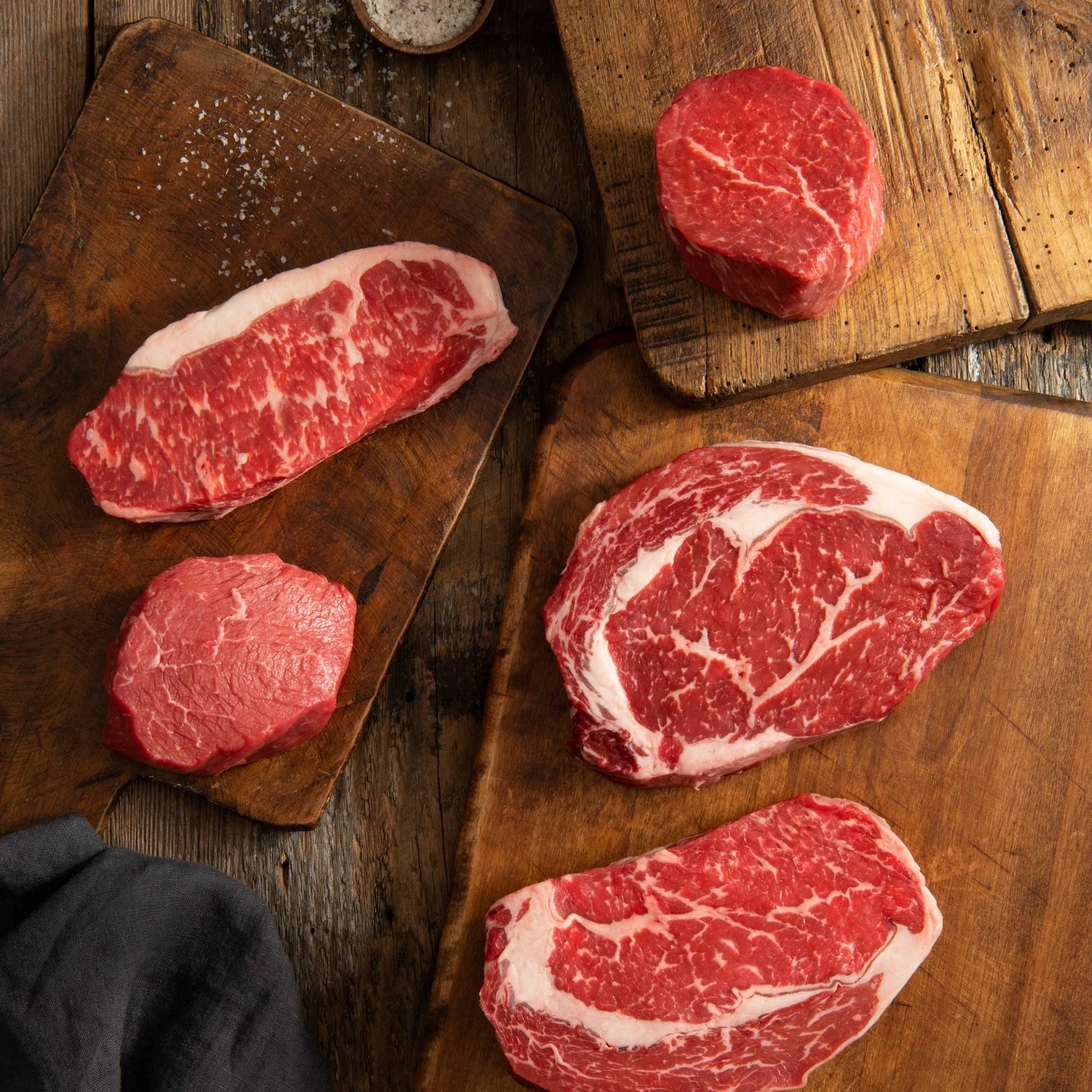 USDA Prime Steak cuts on cutting board displays with seasoning