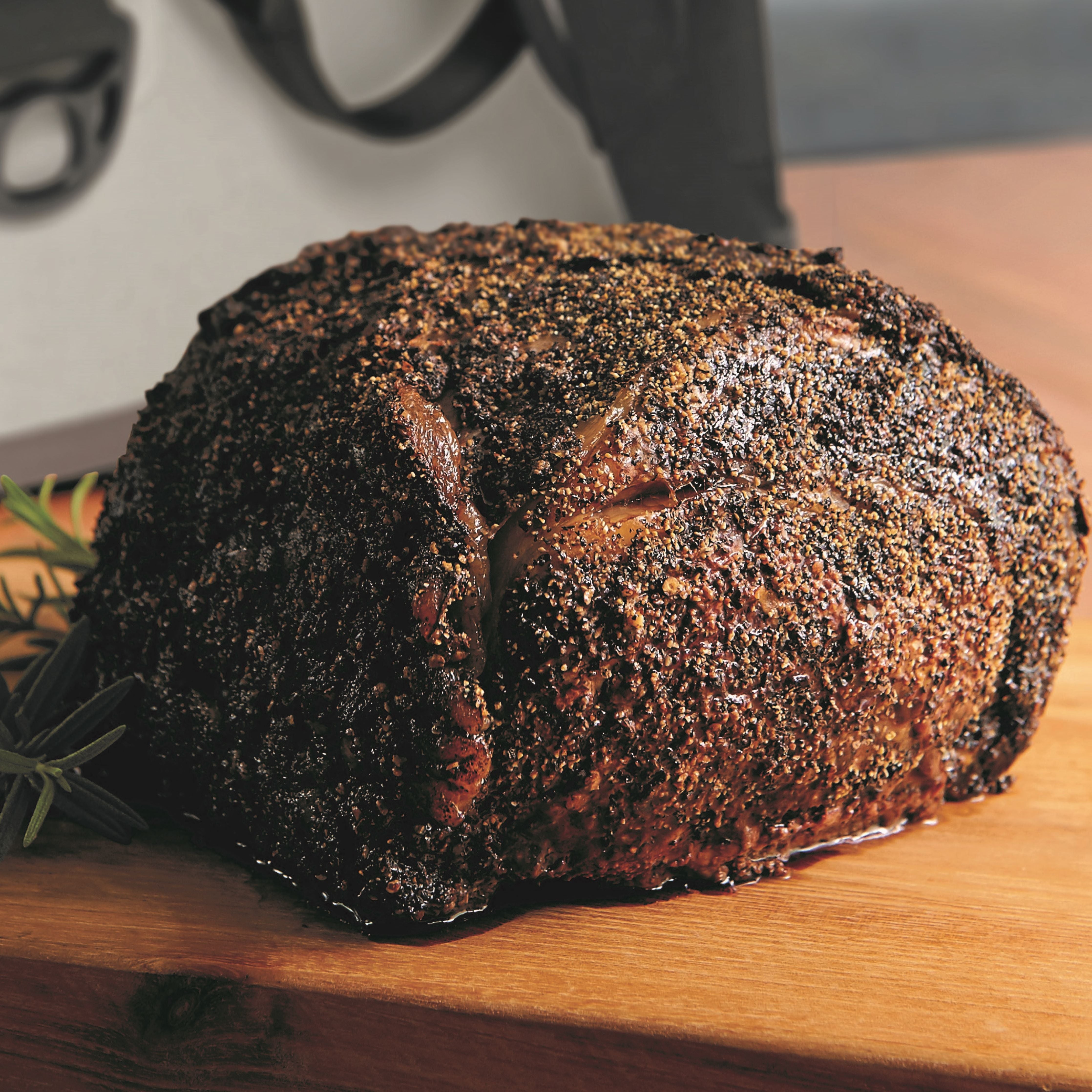 pre-cooked smoked prime rib on cutting board with seasoning